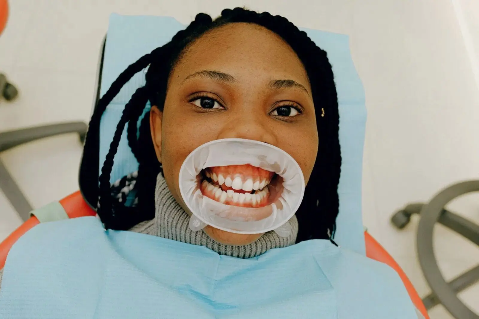 A guest smiling during a teeth whitening session